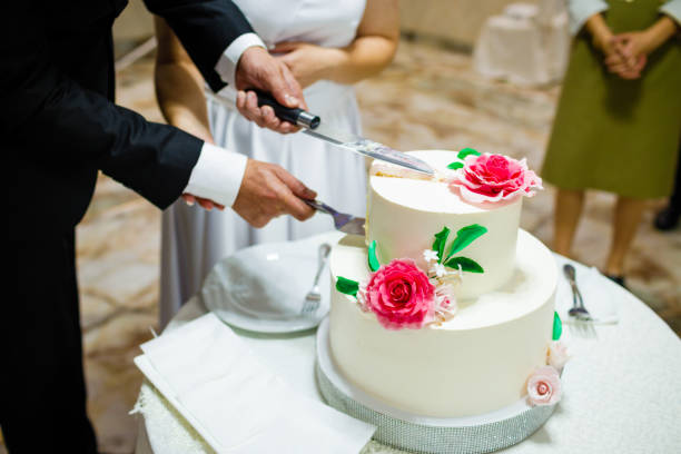 istock White wedding cake with flowers on a wooden table. 1341104453