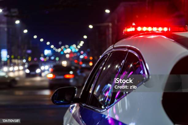 Police Car Lights In Night City With Selective Focus And Bokeh Stock Photo - Download Image Now