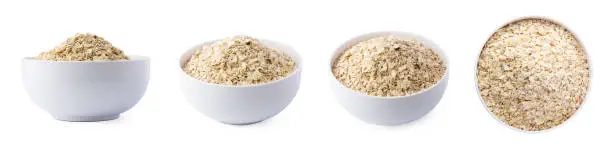 Photo of set of dry common oatmeal in a bowl, cereal grain isolated in white