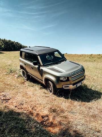 Montalcino, Italy - June 11, 2021 : The New Land Rover Defender parked on the italian summer countryside .