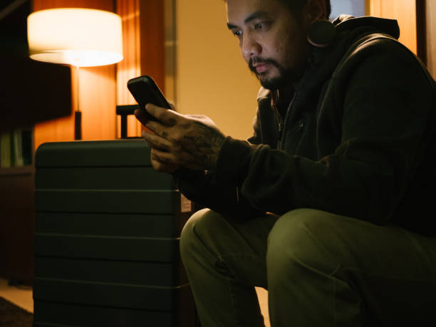 istock Businessman using mobile phone in a hotel lobby. 1341112284