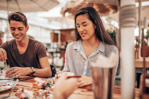 istock mixed racial friends doing breakfast at the cafe 1341112960