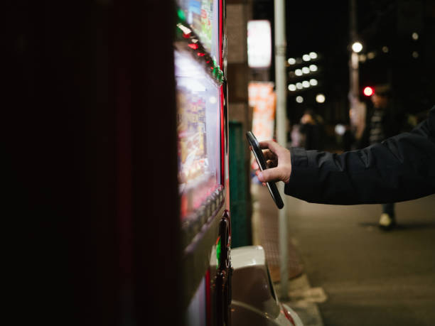 istock Hipster man paying with smartphone to vending machine. 1341113334