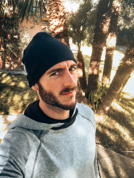 istock serious man with knit hat take a selfie 1341113341