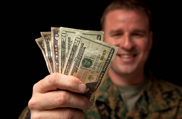 Happy Military Man with Money stock photo