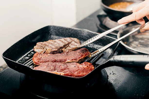 Close up wagyu beef striploin steak with pepper on dark pan stock photo