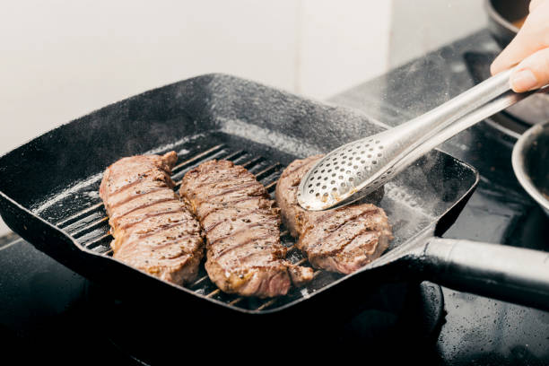 istock Close up wagyu beef striploin steak with pepper on dark pan 1341118055