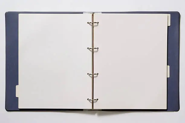 Photo of Isolated shot of opened blank ring binder on white background