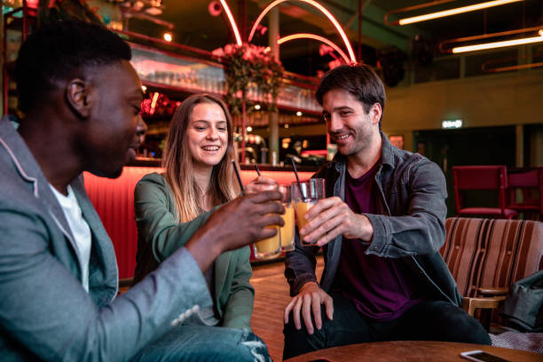 Happy group of friends celebrating in a pub
