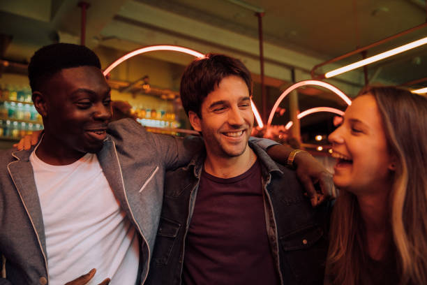 istock Happy group of friends celebrating in a pub 1341120740