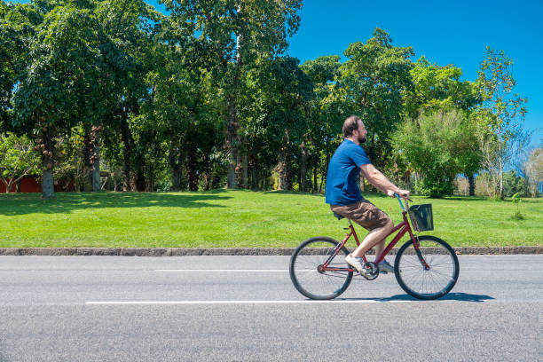 39 year old caucasian man drives the bicycle on a closed asphalt lane for traffic on the day of the photo