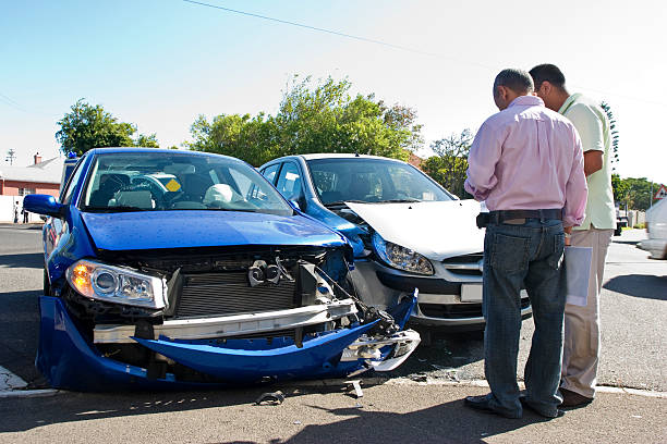 Traffic smash Two men conferring next to two smashed cars. car accident stock pictures, royalty-free photos & images
