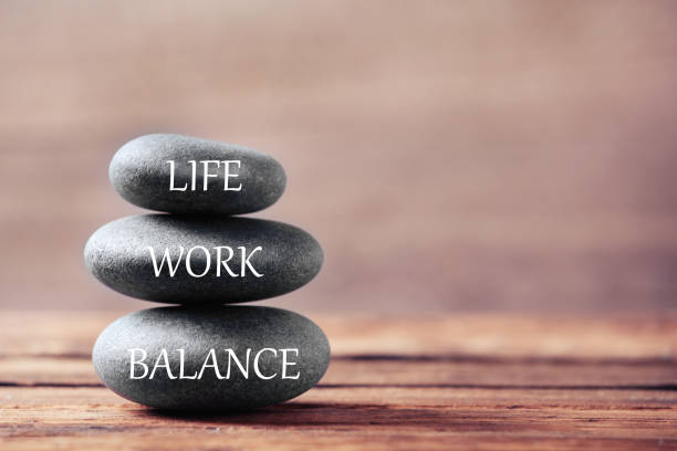 istock Work-life balance concept. Stacked stones on wooden table, space for text 1341125361