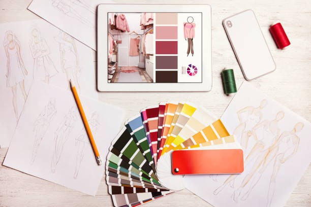 istock Modern designer's workplace with tablet and color palette samples on wooden table , flat lay 1341126589