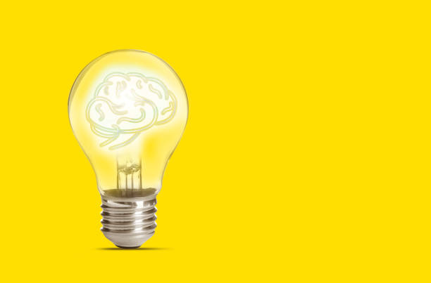 istock Lamp bulb with human brain inside on yellow background, space for text. Idea generation 1341126755