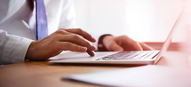 istock Man working on computer at table in office, closeup. Banner design 1341127792