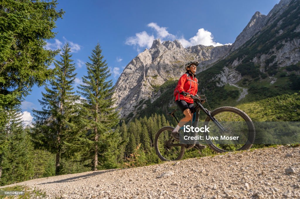 senior woman with electric mountain bike in the austrian alps beautiful active senior woman with electric mountainbike in the spectacular Mountains of Raintal Valley, a side valley of Lechtal, Tyrol, Austria Austria Stock Photo