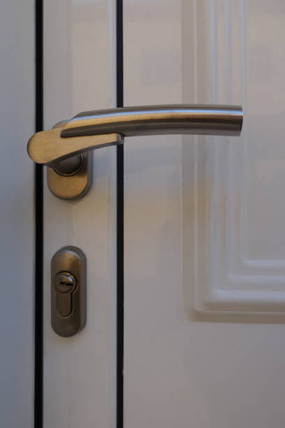 istock Exterior White PVC Door  Handle and Lock Close-up 1341129379