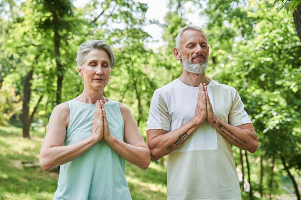 istock Pensioners working out and standing with prayer gesture while feeling as relaxed 1341129832