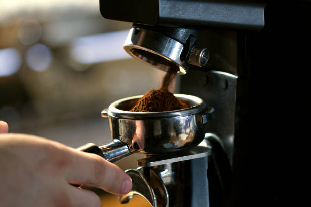 istock coffee grinder grinding coffee pouring into a portafilter 1341131296