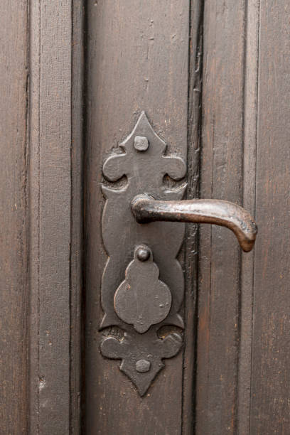 istock Detail of old wooden door with brass handle 1341135607