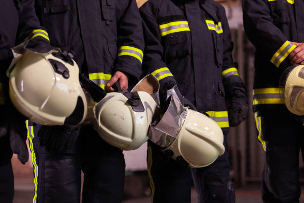 istock Abstract professional firefighters wearing uniforms and protective helmets 1341136060