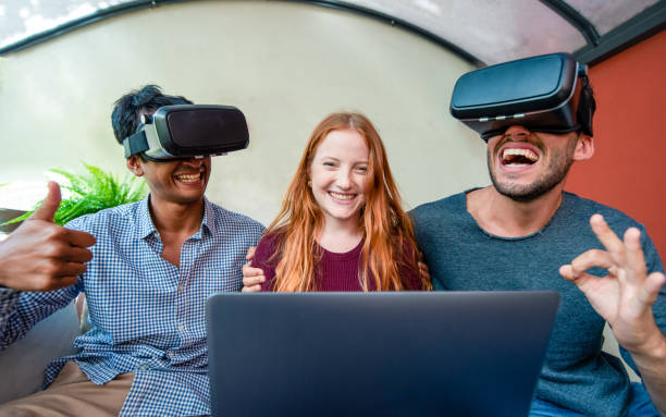 istock young people playing with virtual reality glasses headset, three person playing video game and have fun together, girl smiling and male friends laughing while using augmented reality 1341137625