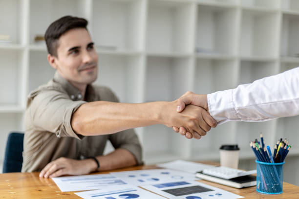 istock A young businessman is shaking hands with a business partner after a discussion. Two businessmen shaking hands. A handshake is a gesture of respect or congratulation. Business etiquette concept. 1341137656