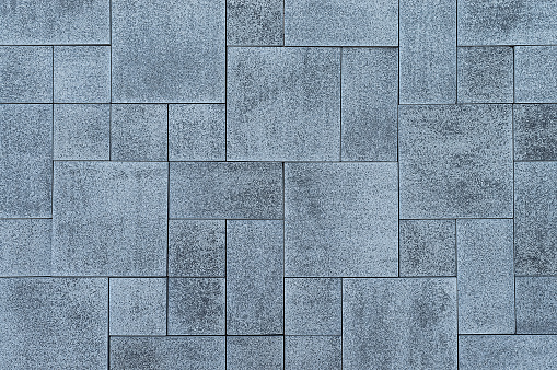 Grey tile paving slab background.