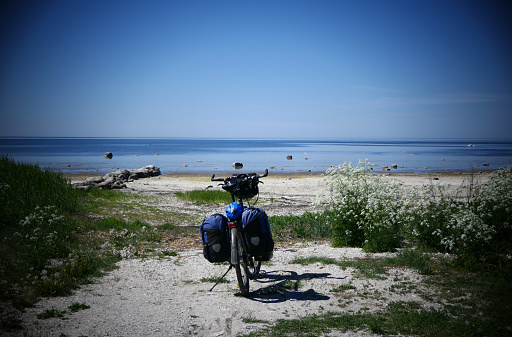 The touring bike is waiting for the cyclist on the beach of the Baltic Sea in Estonia. There is absolute calm in this place.