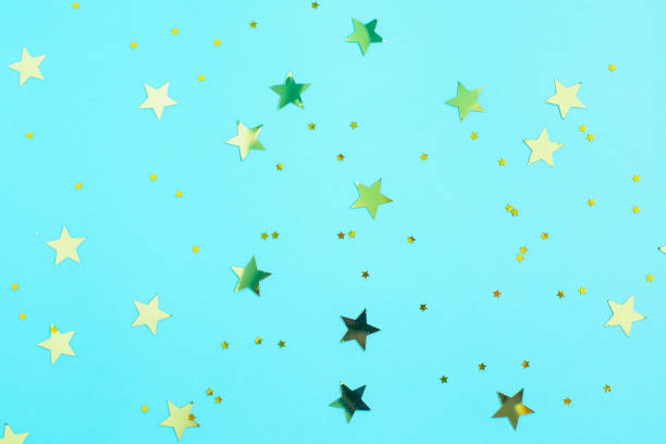 istock Gold glitter stars decorations on blue background. 1341141737