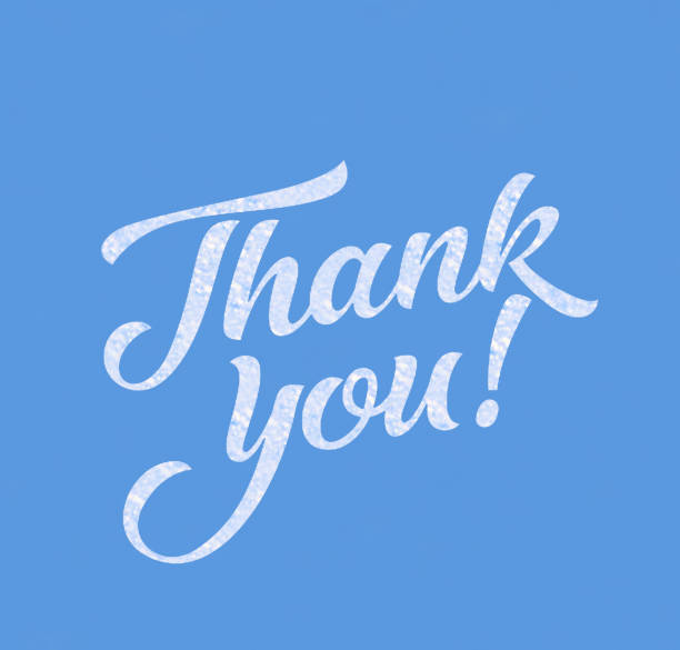 thank you handwritten in the blue sky stock photo