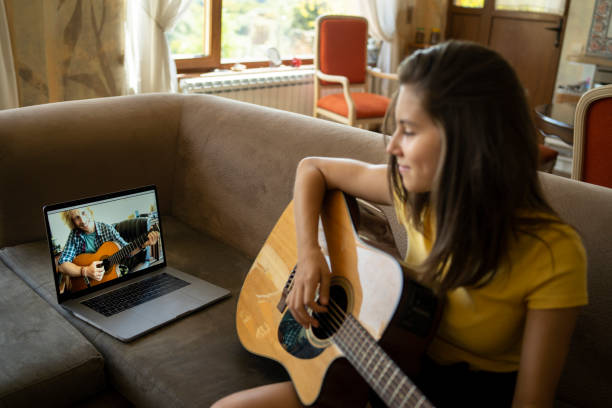 istock Having online guitar lessons online 1341144464