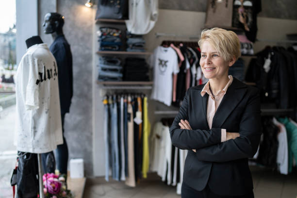 istock Smiling shop assistant watching out for customers 1341145449