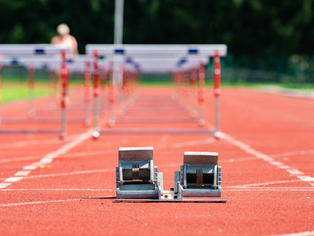 Obstacle course training. Athletics Starting Blocks and red running tracks stock photo