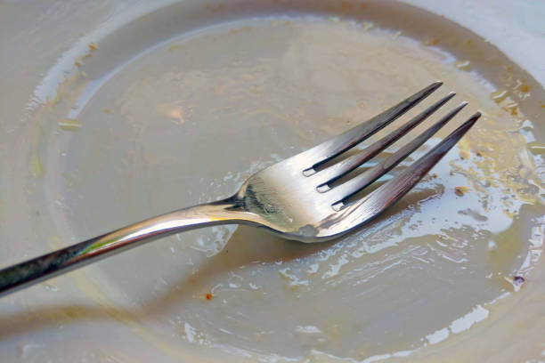 istock There is a dirty fork on the white plate after the meal. 1341145845