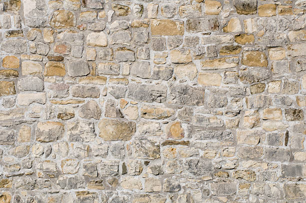 istock A wall made of various different sized rough stones 134114587