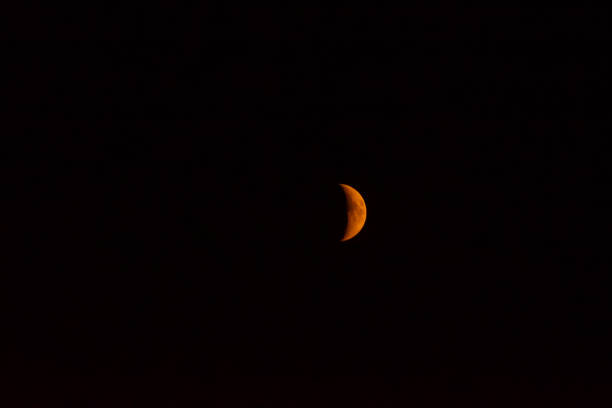 istock Orange red crescent moon against a dark night 1341147989