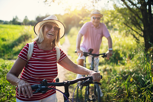 Senior couple are enjoying a bike trip together. 
Nikon D850