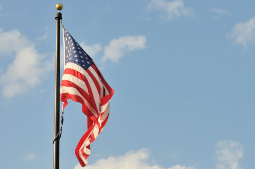 An American Flag against a blue sky with lots of room for copy. Nikon D300 (RAW)