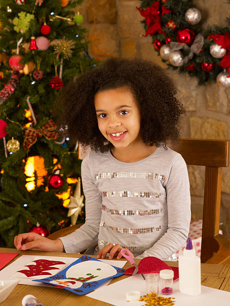 istock Mixed race child making Christmas cards 134115187