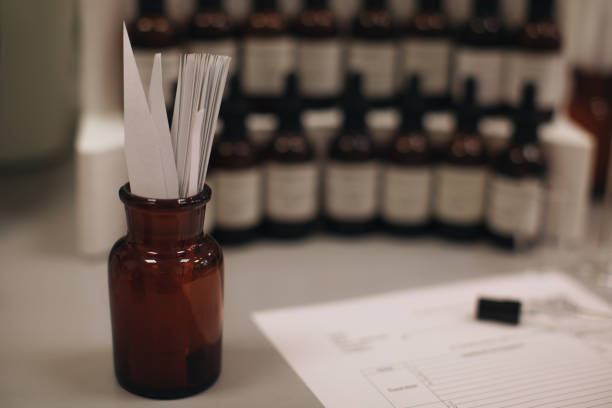 Mockup brown glass bottle with blotter paper for testing smell of essential oil and fragrance oil. Perfume tester paper strips scented stock pictures, royalty-free photos & images