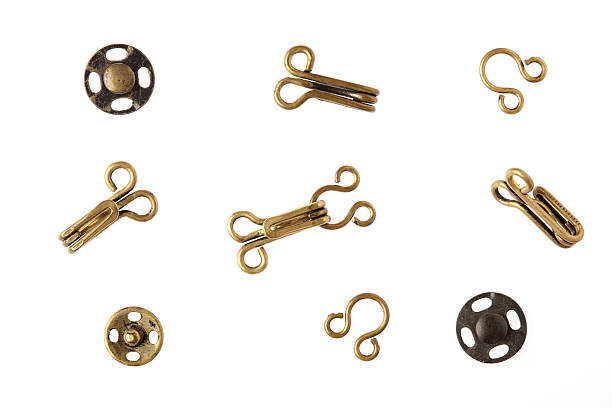 Brass sewing notions against white.