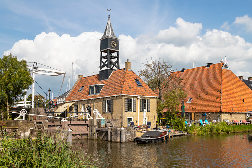 This is a wide angle view of residential homes along the water of the Zaan River on a winter day.