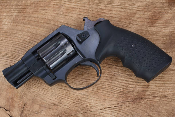 istock Cocked and locked revolver on wooden table 1341156323