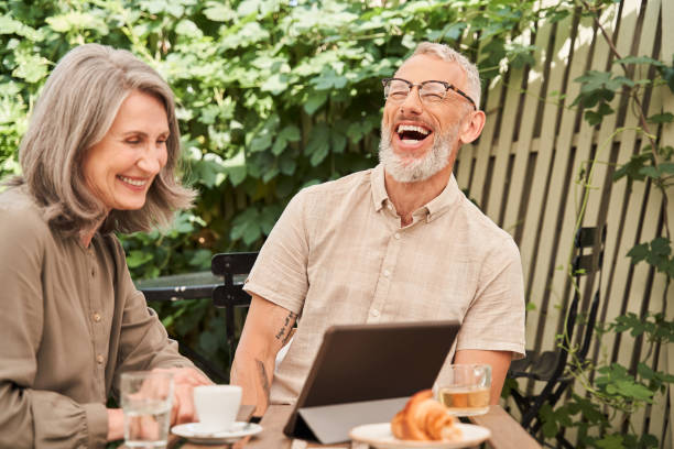 istock Couple laughing out loud while chatting via video call at the tablet 1341157101