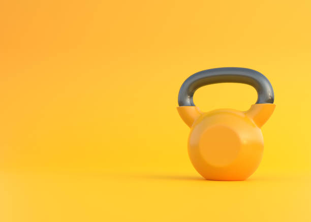 istock One yellow metal weight on a yellow background 1341159517