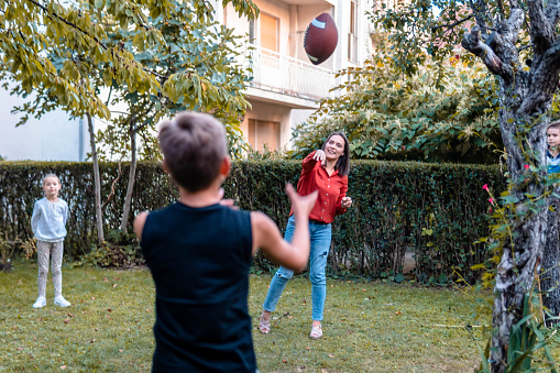 Mother playing football with son