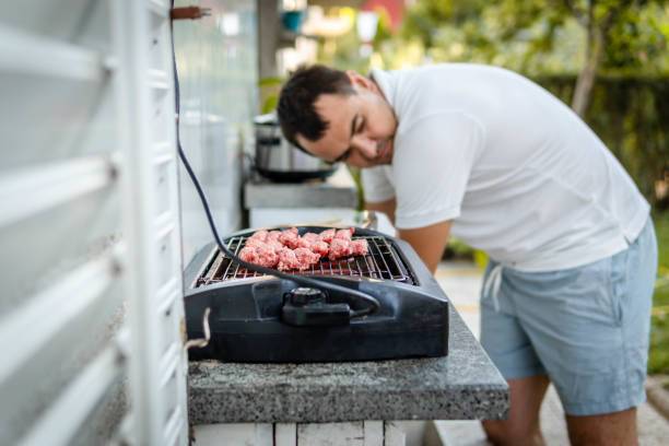 istock Man cooking meat on bbq 1341161247