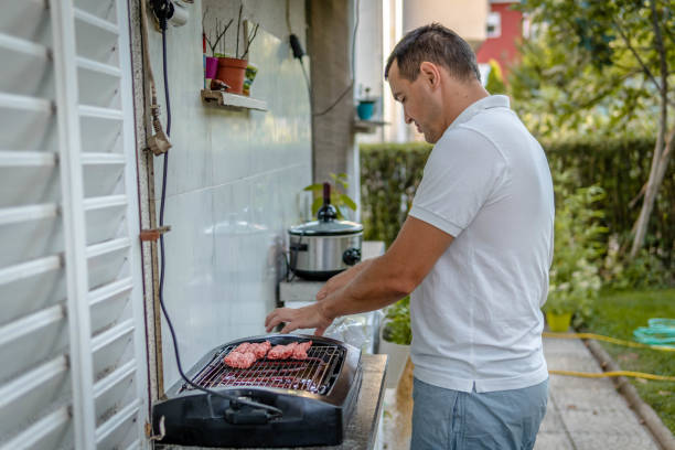 istock Man cooking meat on bbq 1341161335